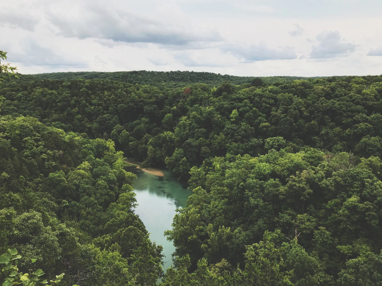 An overhead view of a heavily forested Ozark river valley